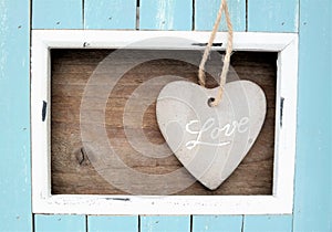 Light blue colored frame and stone heart with the word Love